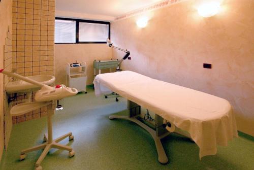 a hospital room with a bed and a window at Hotel Ferrari in Salsomaggiore Terme
