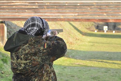 a man in camouflage taking a picture with a gun at Grenlanda in Ulanów