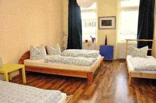 a living room with two beds and a wooden floor at 3-Raum-Fewo-Dresden-Altstadt-L7 in Dresden