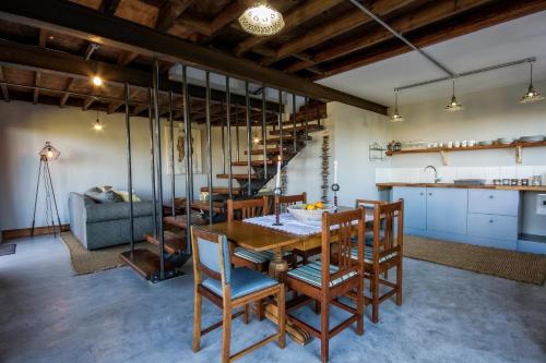 a kitchen and dining room with a table and chairs at A Hilltop Country Retreat in Swellendam