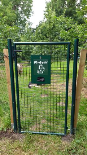 a fence with a sign on it in a park at Fewo Bendig in Neuendorf-Sachsenbande