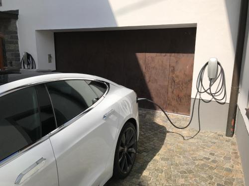 a white car parked next to a garage with a mouse at Gasthof Post in Peilstein im Mühlviertel