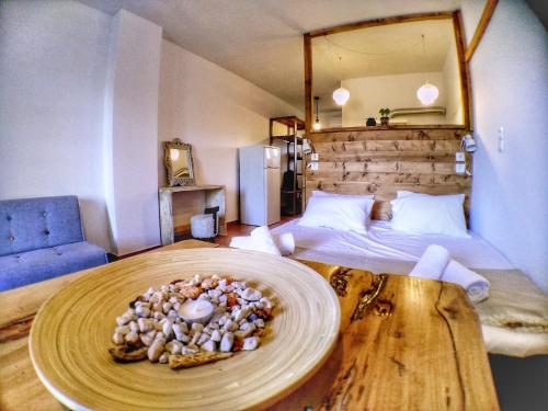a room with a bed and a plate on a table at Althea Beachside Apartments in Potokáki