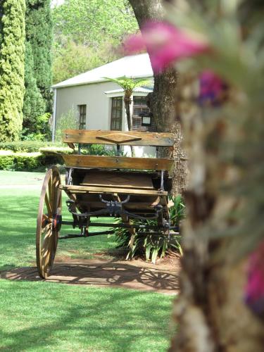 a wooden wagon with a bench on the grass at Haggards on Hilldrop in Newcastle