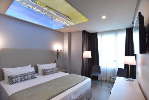 a hotel room with a bed and a window at TC Hotel Doña Luisa in Las Palmas de Gran Canaria