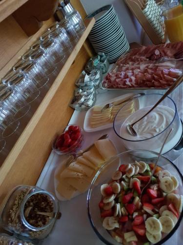 a table topped with plates of food on a table at Garni Rubens B&B in Selva di Val Gardena