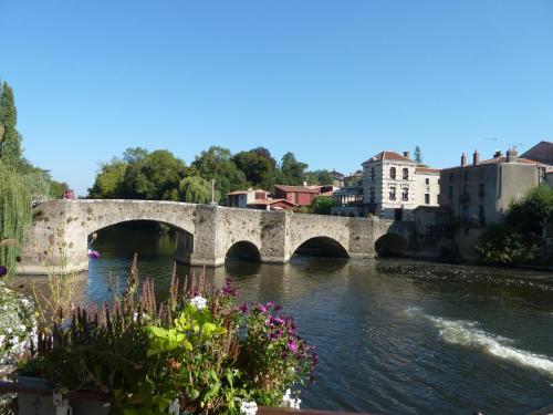 a bridge over a river in a city at maison La Marche in Cugand