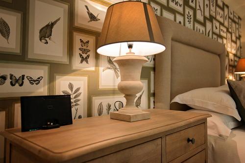 a lamp on top of a dresser in a bedroom at The George Great Oxendon in East Farndon