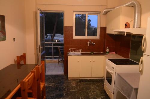 a kitchen with a sink and a stove top oven at Kineta Apartments in Kineta