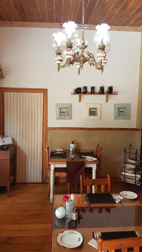 a dining room with a table and a chandelier at Haggards on Hilldrop in Newcastle