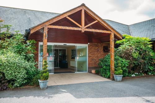 an entrance to a building with a glass door at Draycote Hotel And Whitefields Golf Course in Rugby