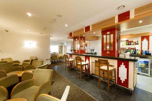 a restaurant with chairs and a bar in a room at The Rutland Hotel in Douglas