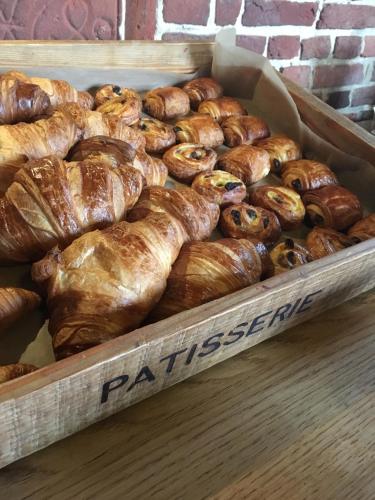 a wooden box filled with different types of pastries at Leeds Castle Stable Courtyard Bed and Breakfast in Maidstone