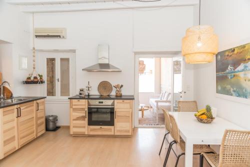 a kitchen and dining room with a table and chairs at Aretousa Deluxe Downtown Apartment in Skala