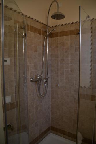a bathroom with a shower with a glass door at Villa Funari Country House in Servigliano