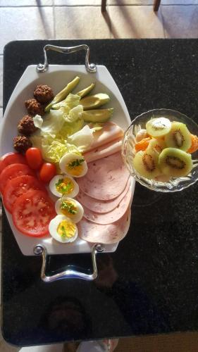 a plate of food with meat and vegetables on a table at At 29 Columba in Groot Brak Rivier