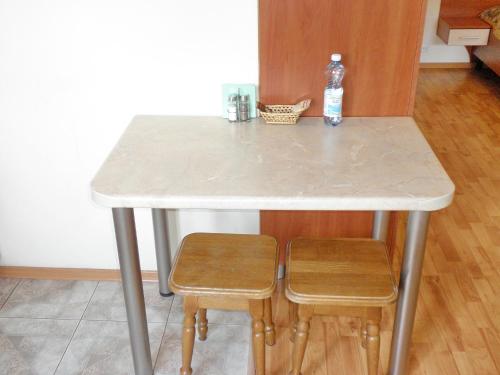 a table with a bottle of water and two stools at Apartment on Nimanska 5 in Kyiv