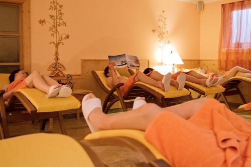 a group of people laying on chairs in a room at Rimlhof by A CASA in Längenfeld