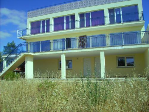a yellow house with blue balconies on top at Villa Ortiga in Mação