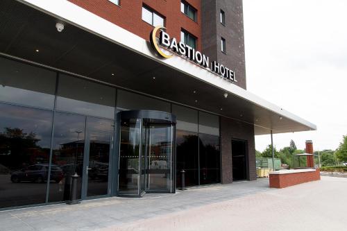 an office building with a sign that reads passion house at Bastion Hotel Eindhoven Waalre in Eindhoven