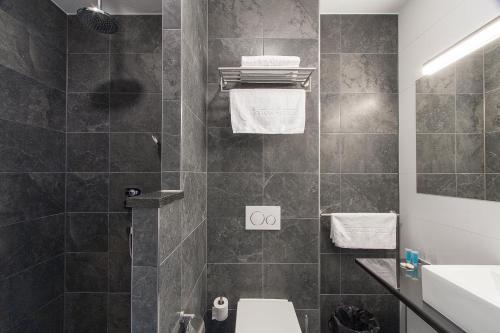 a bathroom with a toilet and a sink at Bastion Hotel Eindhoven Waalre in Eindhoven