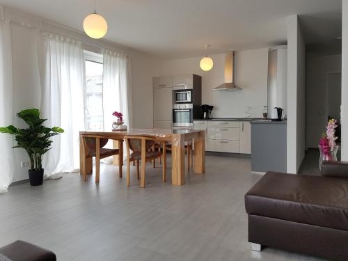 a kitchen and living room with a table and chairs at Apartment by Janzen in Rheine