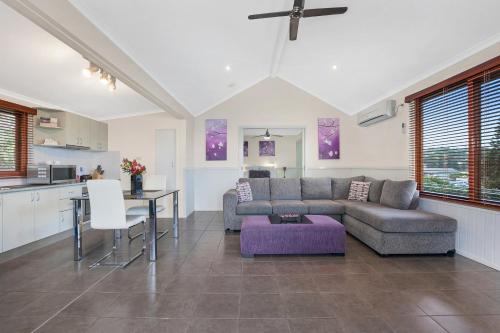 a living room with a couch and a table at Kiama Harbour Cabins in Kiama