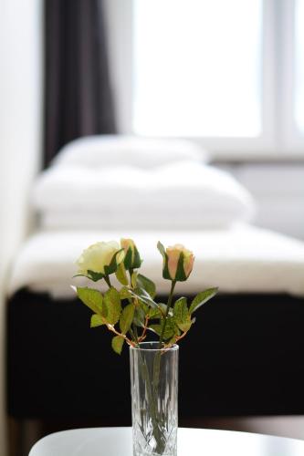 a vase with flowers in it sitting on a table at Alkoven Logi in Ullared