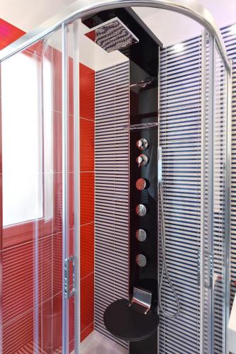 a bathroom with a shower with a glass shower door at CDA Apartament in Minori