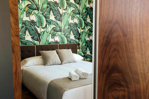 a bedroom with a bed with towels on it at Málaga Premium Hotel in Málaga