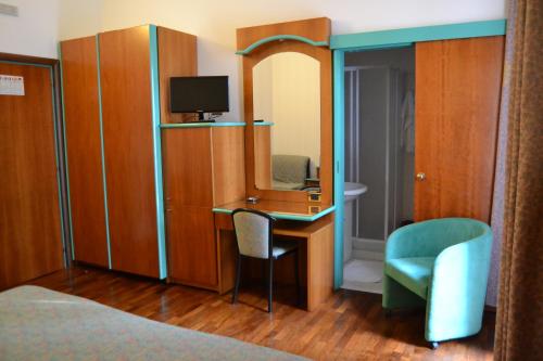 a room with a desk and a chair and a mirror at Hotel ristorante Bellavista in Colonnella