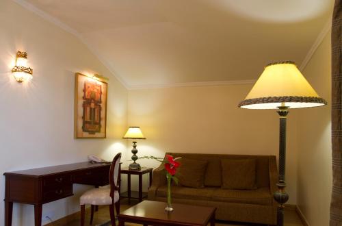 a living room filled with furniture and a lamp at Hotel Quinta Bela S Tiago in Funchal
