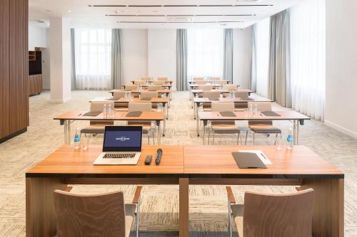 a large room with tables and laptops in it at Grand Ascot Hotel in Kraków