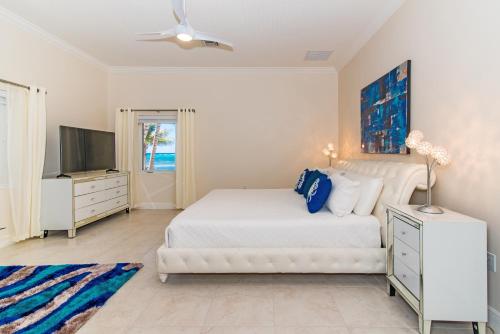 A bed or beds in a room at Sprat Bay Luxury Villa