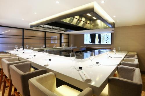 a large dining room with a long white table and chairs at Iberostar Selection Jardín del Sol Suites - Adults Only in Santa Ponsa