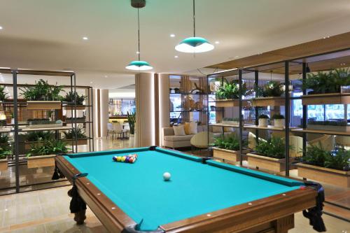 a pool table in a room with plants at Iberostar Selection Jardín del Sol Suites - Adults Only in Santa Ponsa
