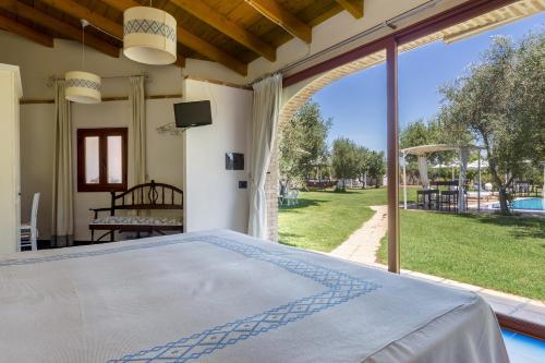 a bedroom with a bed and a large window at Locanda Da Renzo in Siamaggiore