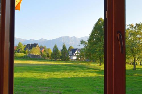 a window with a view of a field of grass at Dom Wczasowy Na Szczycie in Zakopane