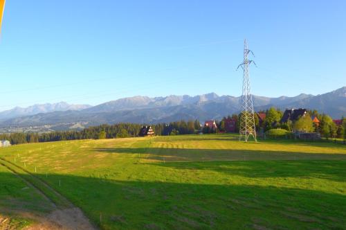 a field with a tower in the middle of a field at Dom Wczasowy Na Szczycie in Zakopane
