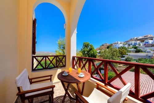 a balcony with a table and chairs and a view at Aspalathos Suites in Akrotiri