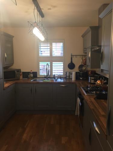 a kitchen with a sink and a counter top at Main House in Rotherham