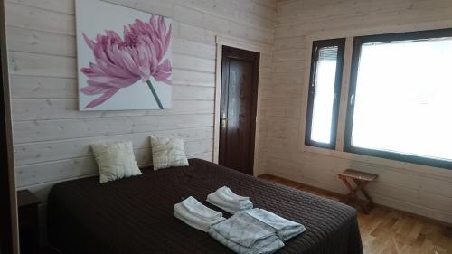 Säng eller sängar i ett rum på Kultainen Kaava Cottages