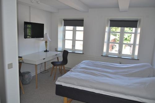 En eller flere senge i et værelse på Bredebro Kro - Bed & Breakfast