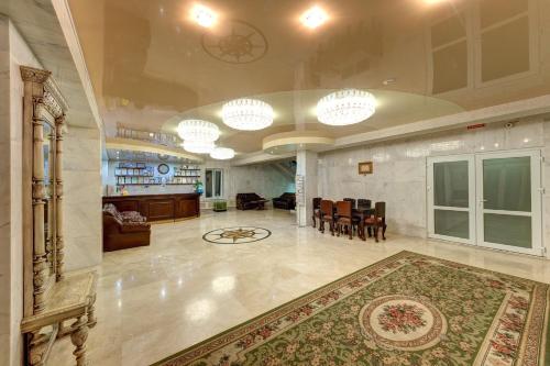 a large living room with a rug on the floor at Aleksandria Hotel in Kyiv