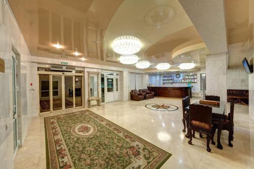 a large living room with a rug on the floor at Aleksandria Hotel in Kyiv