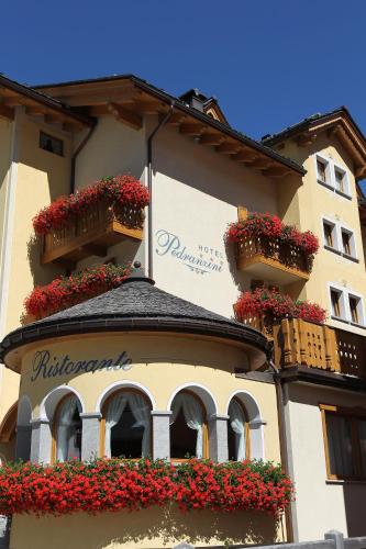 a building with flower boxes and balconies on it at Hotel Pedranzini in Santa Caterina Valfurva