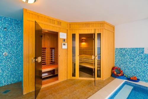 a bathroom with a swimming pool and a room with a shower at Balaton Colors Beach Hotel in Siófok