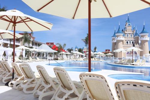 a group of chairs and umbrellas at the disney resort at Bahia Principe Fantasia Punta Cana - All Inclusive in Punta Cana