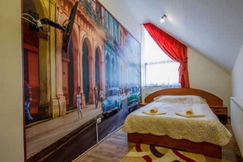 a bedroom with a large painting on the wall at Pension Casa Timar in Braşov