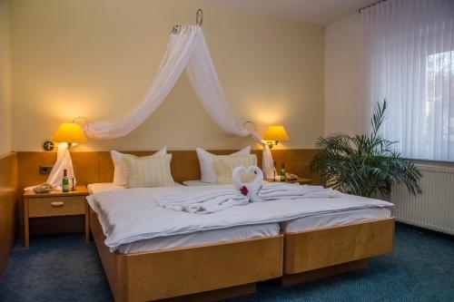 a bedroom with a large bed with a white canopy at Harzparadies in Ilfeld